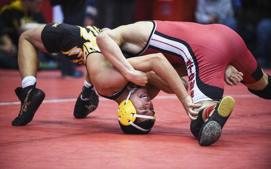 Patch's Elijah Phillips arches out of a pin attempt by Kaiserslautern's Lawrence Abbott during a sectional wrestling meet at Kaiserslautern, Germany, Saturday, Feb. 7, 2015.

Joshua L. DeMotts/Stars and Stripes
