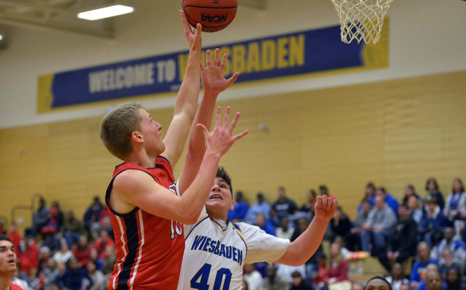 Kaiserslautern's Caleb Chastain goes to the basket against Wiesbaden's Fabrice Niland in a game at Wiesbaden, Saturday, Feb. 7, 2015. Wiesbaden won 49-43.