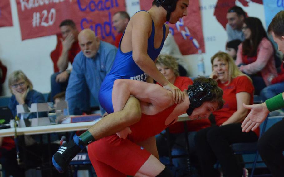 Hohenfels' Jacob Benavides rides the back of Aviano's Mitchel Schaul during a 132-pound match at the Southern section qualifiers at Aviano Air Base, Italy. Benavides won by pin in 5 minutes,10 seconds.