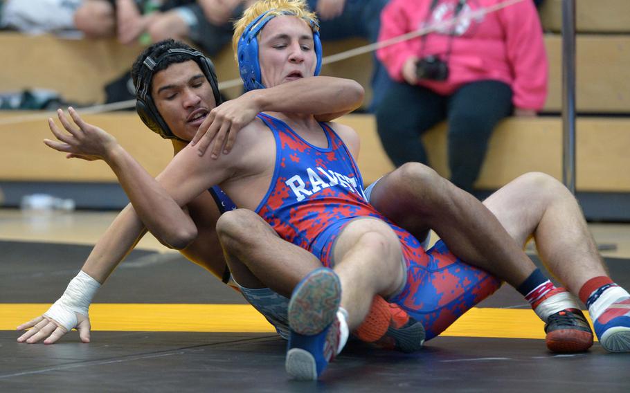 Santos Figueroa of Naples, left, and Ramstein's Thomas Wilby grapple in a 160-pound match on opening day of the DODDS-Europe wrestling championships in Wiesbaden, Germany, Friday, Feb. 13, 2015. Figueroa won the match.