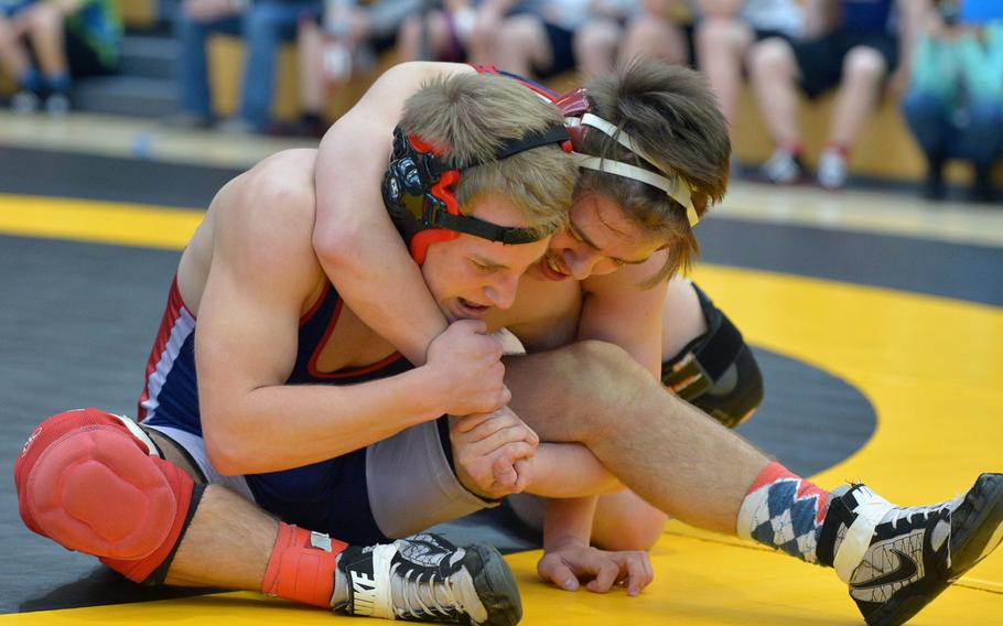 Lakenheath's Zackary Adamson, left, struggles to get out of the grip of Aviano's Shawn McElwee in a 138-pound matchup on opening day of the DODDS-Europe wrestling championships in Wiesbaden, Germany, Friday, Feb. 13, 2015. McEwlee won the match.