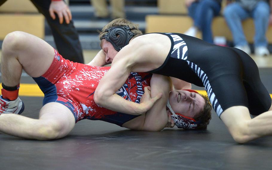 Ian Colbert of Hohenfels, top, puts pressure on Lakenheath's Preston Booth in a 132-pound match on opening day of the DODDS-Europe wrestling championships in Wiesbaden, Germany, Friday, Feb. 13, 2015. Booth was able to turn the tables and win the match.