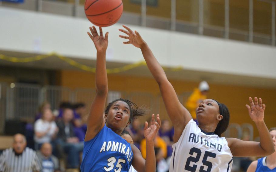 Rota's Marquette Magwood gets off a shot against Aviano's Jasmine Cole in a Division II game on opening day of the DODDS-Europe basketball championships in Wiesbaden, Germany, Wednesday, Feb. 18, 2015. Rota won the game 26-18.