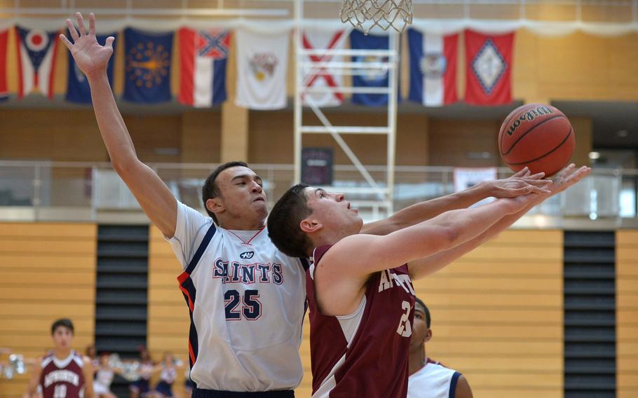 Aviano's Dundrey Peoples, left, tries to stop AFNORTH's Logan Harless from scoring in a Division II game on opening day of the DODDS-Europe basketball championships in Wiesbaden, Germany, Wednesday, Feb. 18, 2015. AFNORTH, seeded eighth, beat top-seeded Aviano.49-33.