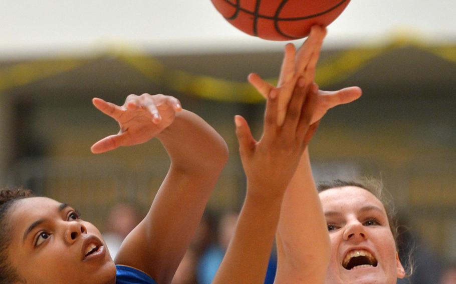 Ansbach's Malaika Stephenson, left, and Black Forest Academy's Cailynn Campbell fight for a rebound in a Division II game on opening day of the DODDS-Europe basketball championships in Wiesbaden, Germany, Wednesday, Feb. 18, 2015. Top-seeded BFA won 52-12 against the eighth-seeded Cougars.