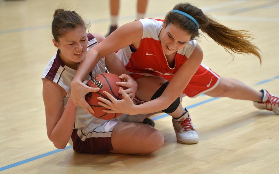 AFNORTH's Eliska Volencova and American Overseas School of Rome''s Candy Martinez fight for the ball in a Division II game on opening day of the DODDS-Europe basketball championships in Wiesbaden, Germany, Wednesday, Feb. 18, 2015. AFNORTH beat AOSR 36-19.