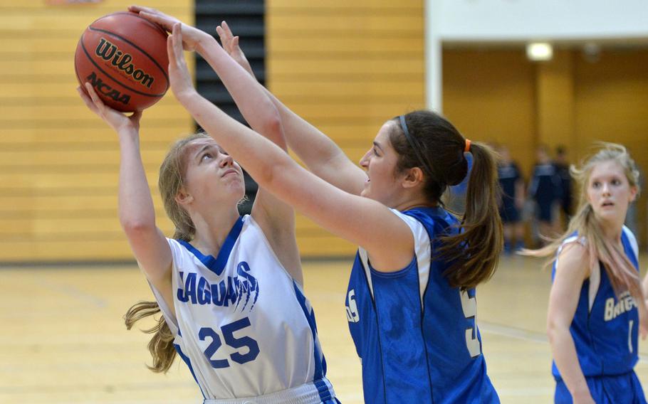 Sigonella's Sydney Baker tries to get a shot off against Laura Heibling of Brussels in opening day Division III action at the DODDS-Europe basketball finals in Wiesbaden, Germany, Thursday, Feb. 19, 2015. Sigonella won 30-8.
