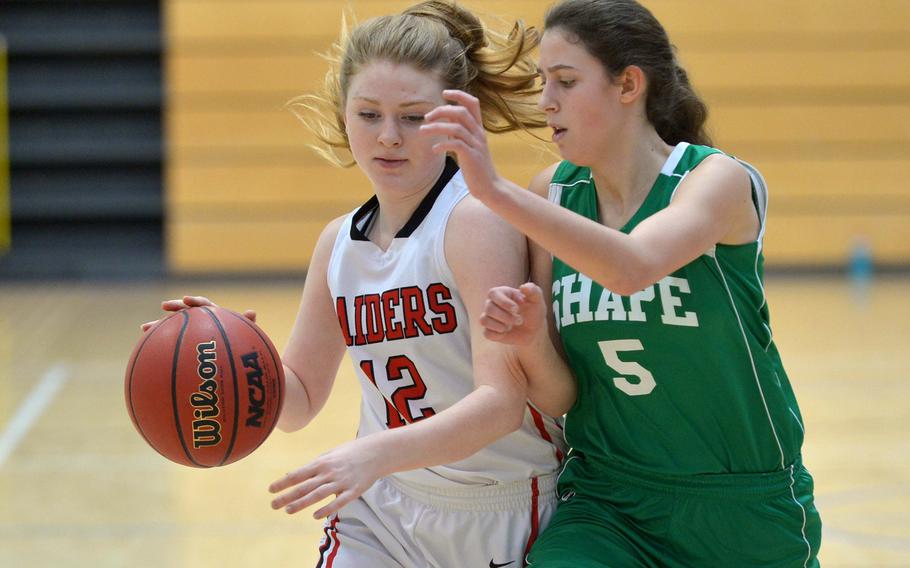 Kaiserslautern's Althea Honan drives up the court against SHAPE's Begona Rodriguez in Division I action at the DODDS-Europe basketball finals in Wiesbaden, Germany, Thursday, Feb. 19, 2015. Kaiserslautern won the game 30-19.