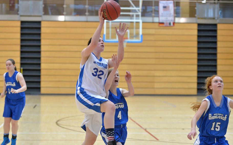 Sigonella's Elizabeth Camus goes in for a shot against Alice Bigalow of Brussels in opening day Division III action at the DODDS-Europe basketball finals in Wiesbaden, Germany, Thursday, Feb. 19, 2015. Sigonella won 30-8.