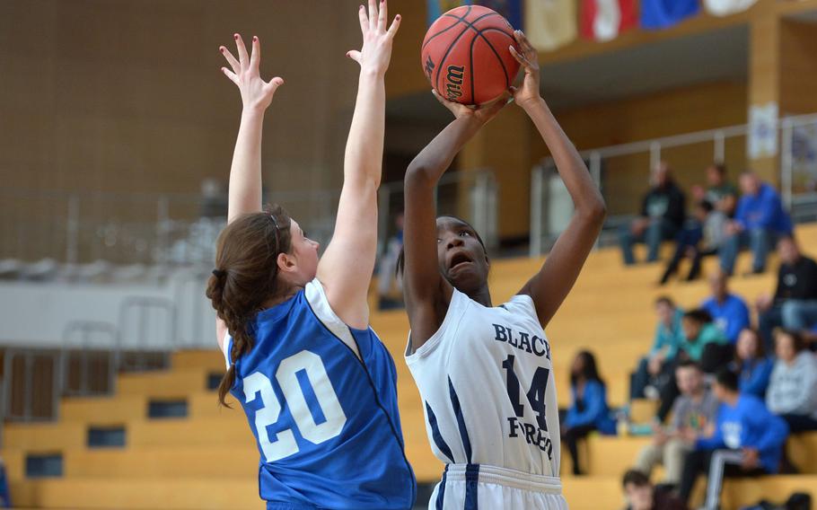 Black Forest Academy's Eseli Emasealu attempt a shot over Hohenfels' Amelia Heath in a Division II semifinal at the DODDS-Europe basketball championships in Wiesbaden, Germany, Friday, Feb. 20, 2015. BFA won 26-19 to advance to Saturday's final.