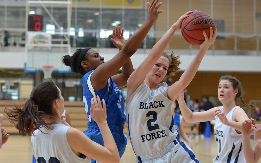 Black Forest Academy's Emily Campbell pulls down a rebound against Hohenfels' Payton Chandler in a Division II semifinal at the DODDS-Europe basketball championships in Wiesbaden, Germany, Friday, Feb. 20, 2015. BFA won 26-19 to advance to Saturday's final.