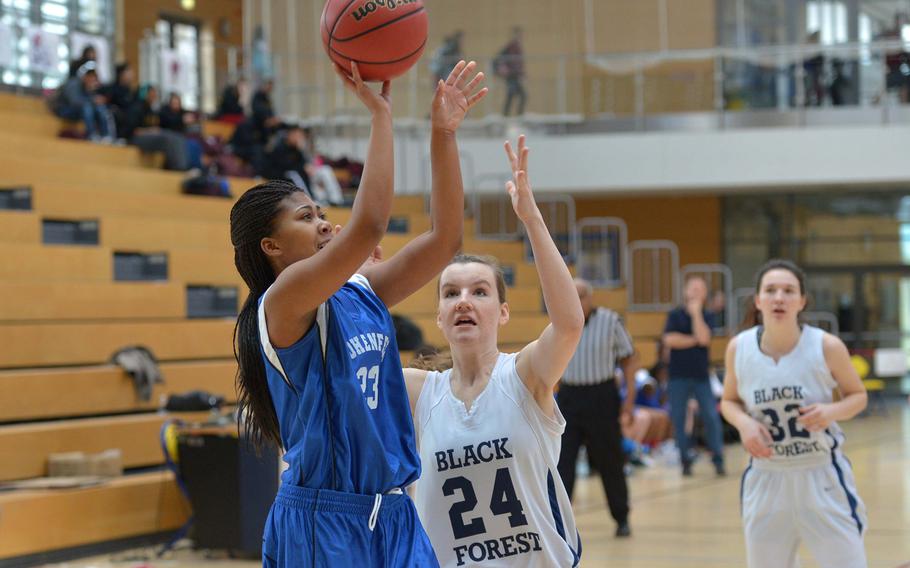 Hohenfels' Tamia McDaniels gets off a shot as Black Forest Academy's Cailynn Campbell comes in to defend in a Division II semifinal at the DODDS-Europe basketball championships in Wiesbaden, Germany, Friday, Feb. 20, 2015. BFA won 26-19 to advance to Saturday's final.