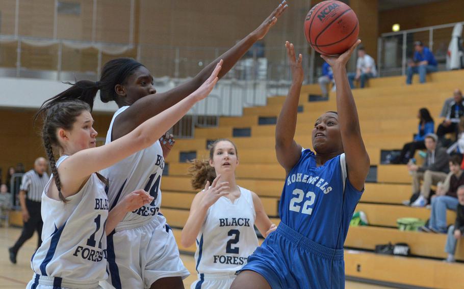 Hohenfels' Payton Chandler shoots over Black Forest Academy's Katie Greathouse, left, and Eseli Emasealu in a Division II semifinal at the DODDS-Europe basketball championships in Wiesbaden, Germany, Friday, Feb. 20, 2015. BFA won 26-19 to advance to Saturday's final.