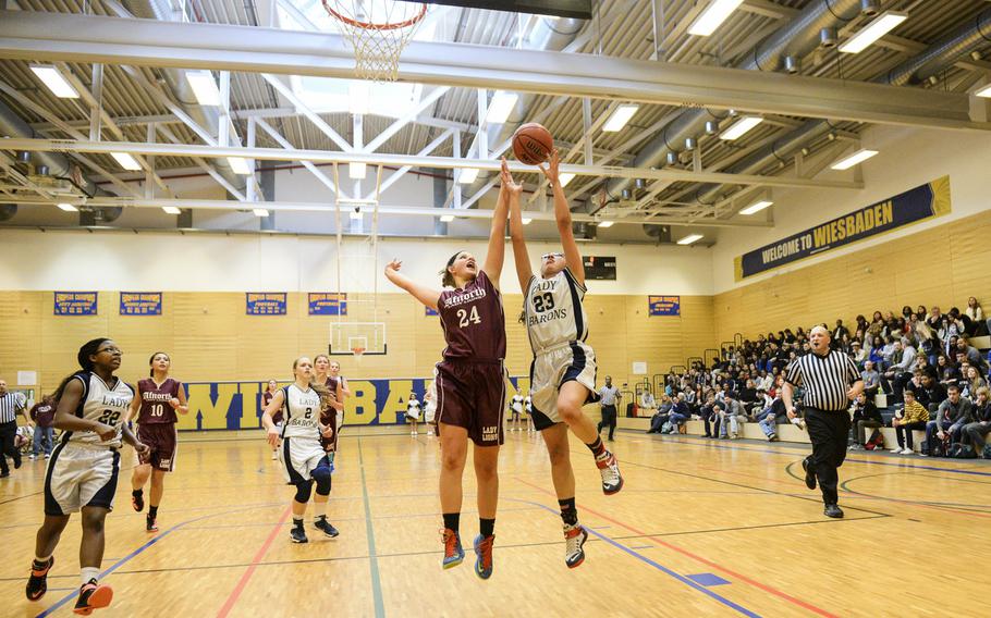 Bitburg's Victoria Porras lays the ball up past AFNORTH's Grace Phillips on a fast break in the semifinals of the DODDS-Europe tournament, Friday, Feb. 20, 2015.