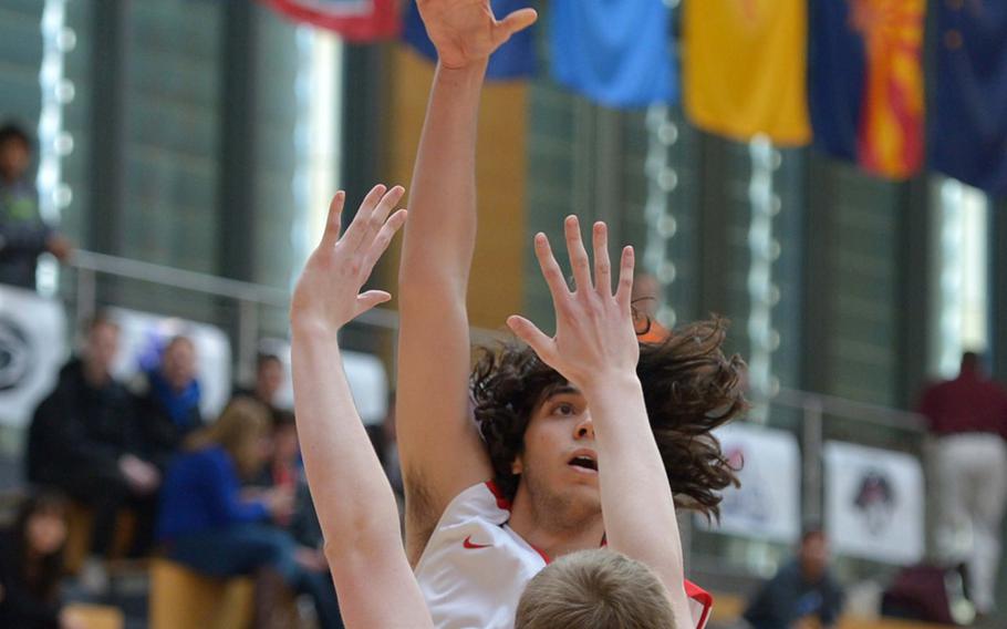 American Overseas School of Rome's Francesco Gristina shoots over Black Forest Academy's Kaden Proctor  in a Division II semifinal at the DODDS-Europe basketball championships in Wiesbaden, Germany, Friday, Feb. 20, 2015. AOSR beat BFA 63-40 to advance to Saturday's final.