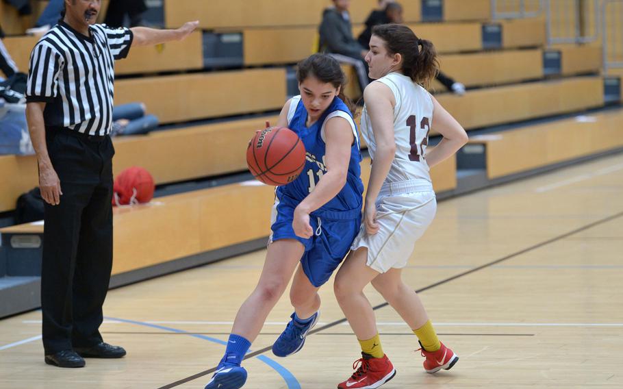 Brussels' Chloe Proietto drives past Baumholder's Claudia Seal in a Division III semifinal at the DODDS-Europe basketball championships in Wiesbaden, Germany, Friday, Feb. 20, 2015. Baumholder won 25-14 to advance to Saturday's final.