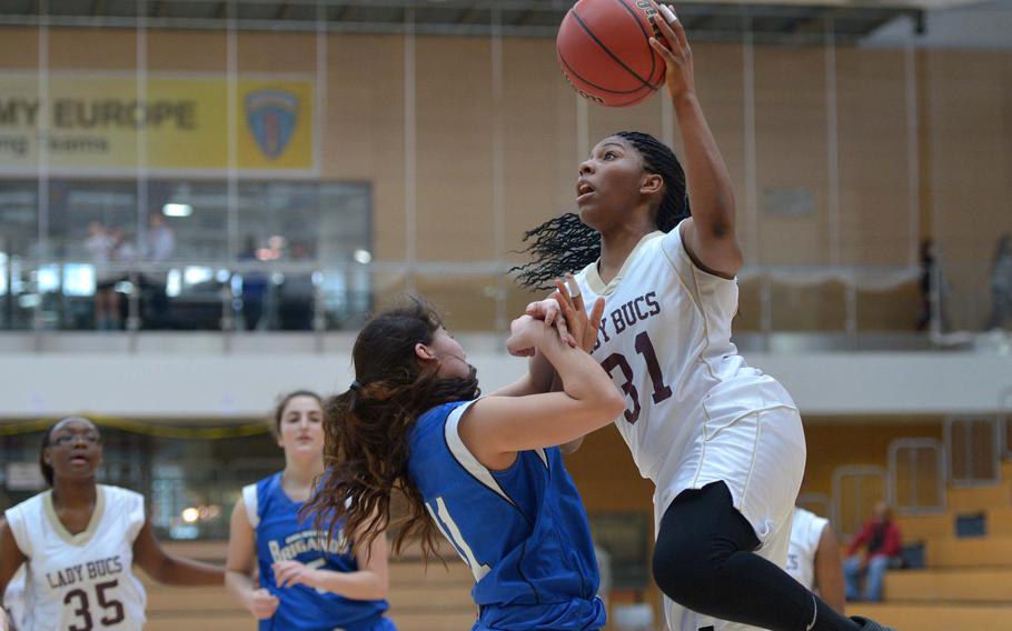 Baumholder's Eliyah Tillman goes to the basket against Brussels' Chloe Proietto in a Division III semifinal at the DODDS-Europe basketball championships in Wiesbaden, Germany, Friday, Feb. 20, 2015. Baumholder won 25-14 to advance to Saturday's final.