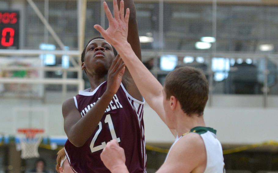 Baumholder's Jaylon Bentley shoots over Alconbury's Joey Behr in a Division III semifinal at the DODDS-Europe basketball championships in Wiesbaden, Germany, Friday, Feb. 20, 2015. Baumholder won 44-29 to advance to Saturday's final.