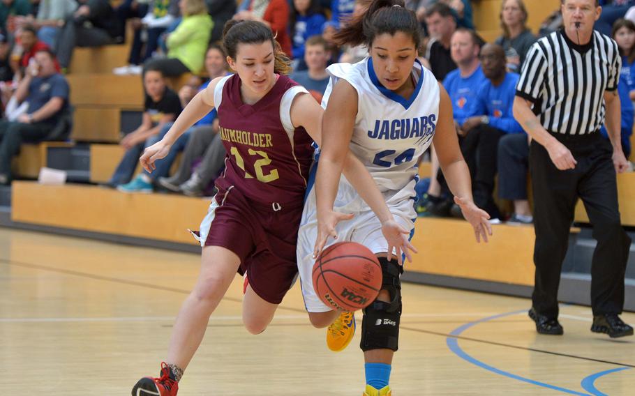 Baumholder's Claudia Seal tries to stop Sigonella's Kisiah Chandler's drive in the girls Division III championship game in Wiesbaden, Germany, Saturday Feb. 21, 2015. Baumholder beat Sigonella in overtime 28-24 to take the title.