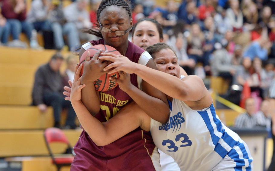 Baumholder's Imaya Sharpe and Sigonella's Sydney Moore fight for the ball in the girls Division III championship game in Wiesbaden, Germany, Saturday Feb. 21, 2015. Baumholder beat Sigonella in overtime 28-24 to take the title.