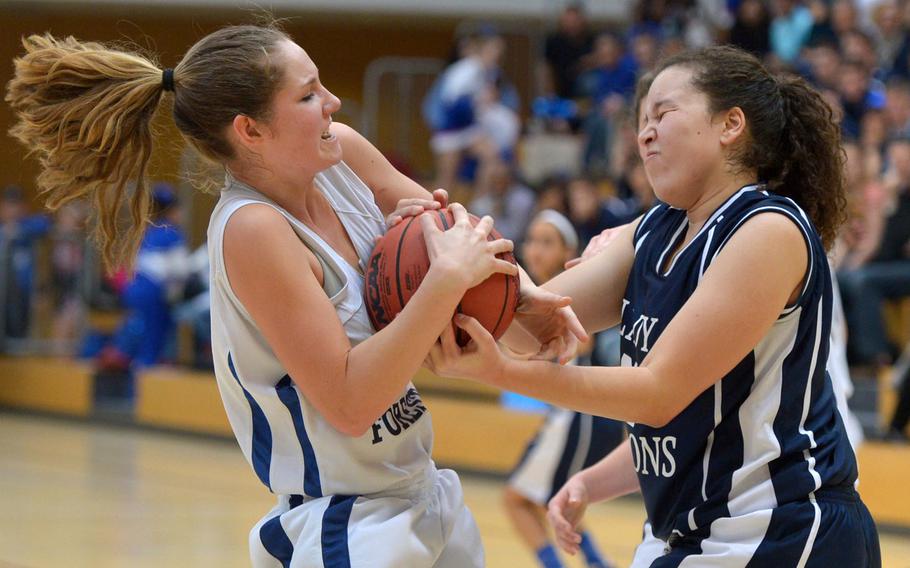 Black Forest Academy's Emily Campbell, left, and Bitburg's Elise Rasmussen fight for the ball in the girls Division II championship game in Wiesbaden, Germany, Saturday Feb. 21, 2015. Bit burg defeated BFA 34-27 for the title.