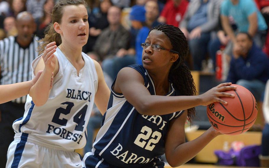 Bitburg's Destiny Walker looks for a teammate as she is pressured by Black Forest Academy's Cailynn Campbell in the girls Division II championship game in Wiesbaden, Germany, Saturday Feb. 21, 2015. Bitburg defeated BFA 34-27 for the title.