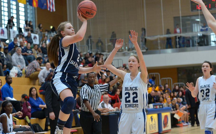 Bitburg's Alexa Landenberger gets past Black Forest Academy's Anna Kragt for a shot in the girls Division II championship game in Wiesbaden, Germany, Saturday Feb. 21, 2015. Bitburg defeated BFA 34-27 for the title.