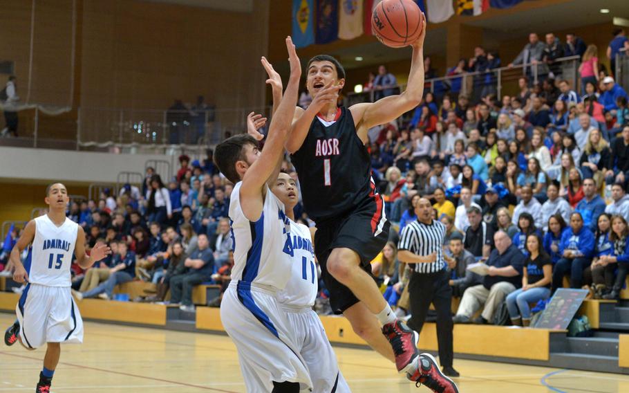 American Overseas School of Rome's Otis Reale goes to the basket against Rota's Luis Fuertes in the boys Division II championship game at the DODDS-Europe basketball championships in Wiesbaden, Germany, Saturday Feb. 21, 2015. 