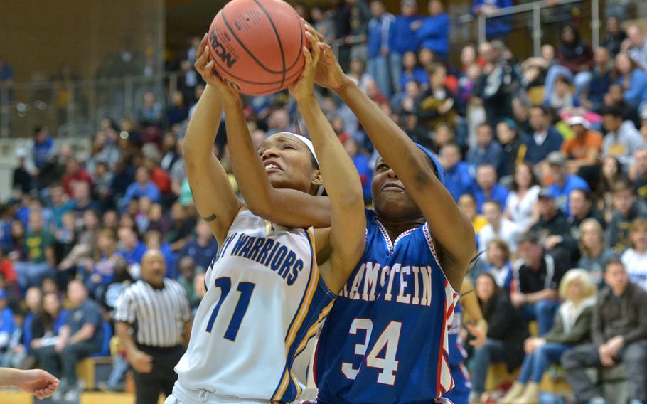 Wiesbaden's Cierra Martin and Ramstein's Amethyst Rorie fight for a rebound in the girls Division I championship game at the DODDS-Europe basketball championships in Wiesbaden, Germany, Saturday Feb. 21, 2015. Wiesbaden beat Ramstein 32-26 to defend their title.