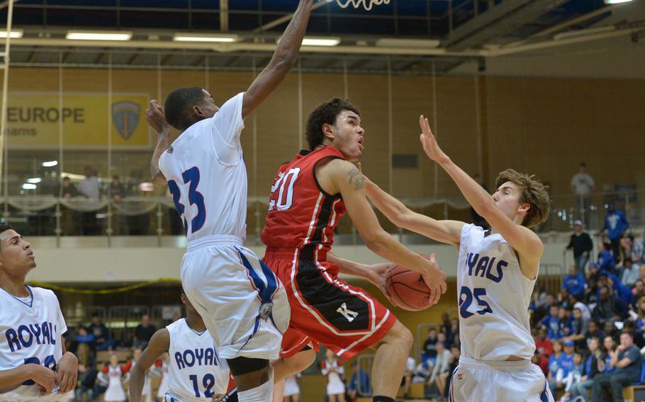 Kaiserslautern's Jeremy Morgan tries to go for a layup between Ramstein's Trey Bailey, left, and Mitchell McKinney in the boys Division I championship game at the DODDS-Europe basketball championships in Wiesbaden, Germany, Saturday Feb. 21, 2015. Ramstein beat Kaiserslautern 47-32 for the title. Morgan was fouled on the play.