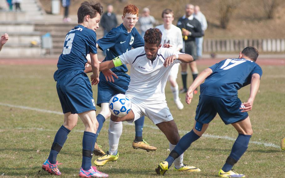 Vilseck team captain Pierre Elysee finds himself surrounded by Ramstein defenders during the Falcons' 2-1 upset over the Royals on  Mar. 21, 2015.