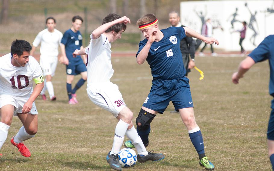 Ramstein's Travis McCloskey threads the ball through half of Vilseck's midfielders during the DODDS-Europe Division I soccer opener, Mar. 21, 2015. Vilseck came away with the victory, 2-1 over the visiting Royals. 