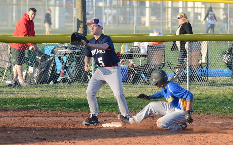 Ansbach's Yadial Rodriguez slides in to third, while Aviano's Nicolas Routier looks for the throw from home plate Saturday at Aviano Air Base, Italy. Ansbach won 10-7. 