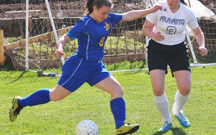 Ansbach's Nastaya Henry kicks the ball away from Aviano's Leah Ives during a 4-4 tie Friday between the two teams at Aviano Air Base in Italy.


