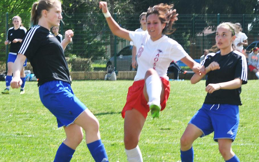 American Overseas School of Rome's Alessandra Valcastelli, who scored her team's second goal Friday, kicks the ball up high between two Hohenfels defenders.
