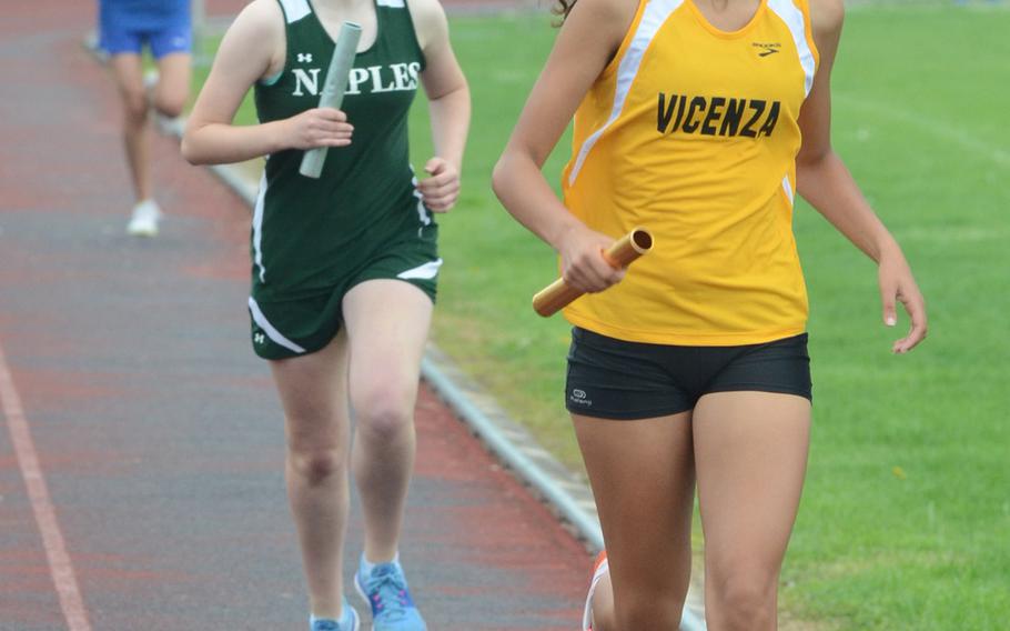 Vicenza's Kate Wilkins pulls ahead of Naples' Ada Laurer Saturday during the 4x800 relay event at Creazzo, Italy. The Cougars won with a time of 12 minutes, 45.58 seconds.