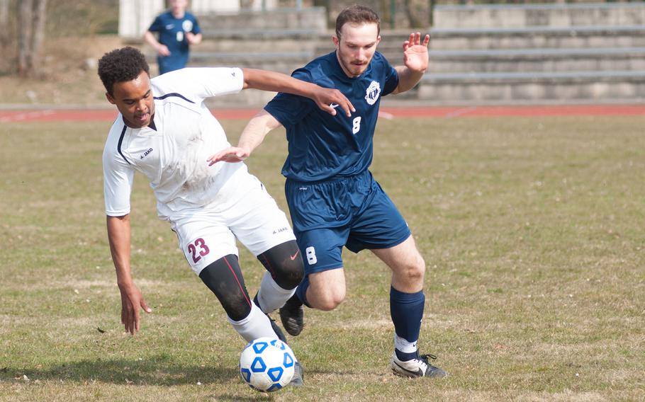 Vilseck's Malachi Alston fights for a ball with Ramstein's Dominic Kubas during the DODDS-Europe Division I soccer opener, Mar. 21, 2015. Alston scored one of Vilseck's two goals, lifting his team to victory, 2-1 over the visiting Royals. 