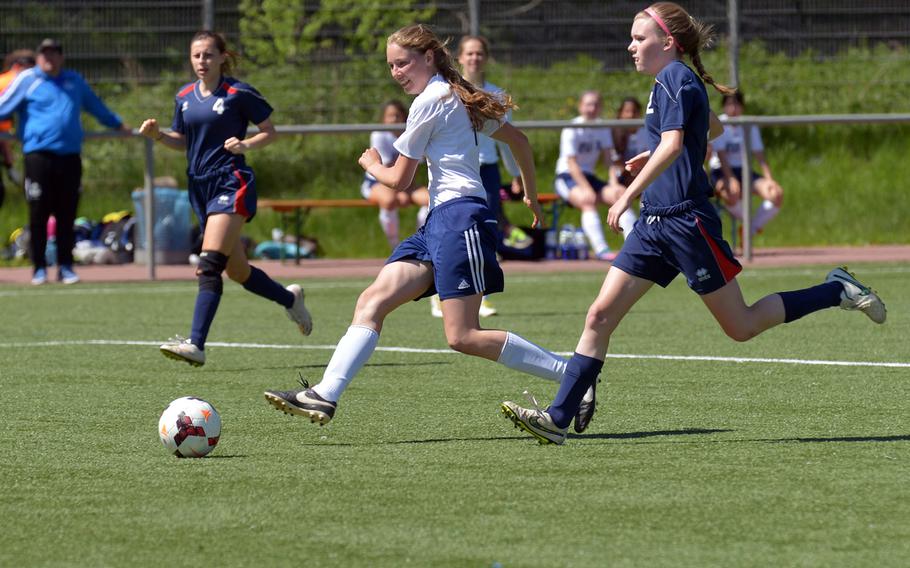 Black Forest Academy's Michal Petros scores a goal in BFA's 4-0 win over Aviano in opening-day Division II action at the DODDS-Europe soccer finals in Landstuhl, Germany. At left is Aviano's Eliana Colletti, at right Natalie Abernathy.
