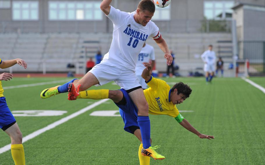 Rota's Matthew Gramkee and Ansbach's Edwin Pope collide as they go for the ball in a Division II match at the DODDS-Europe soccer championships in Kaiserslautern, Germany. Ansbach won 2-0.