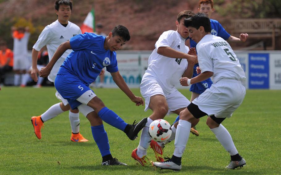 Ramstein's Nicholas Meza, left, tries to get a shot off against Joseph Cianciaruso, center, and Ivan Altamira in a Division I game at the DODDS-Europe soccer championships at Reichenbach, Germany. Ramstein won 3-1.