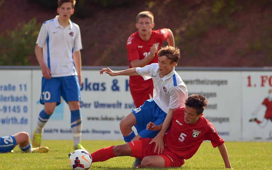 Kaiserslautern's Jonathan Millet tackles International School of Brussels' Livio de Bok in a Division I semifinal at the DODDS-Europe soccer championships at Reichenbach, Germany. ISB won the game 5-3 to advance to Thursday's final against Ramstein.
