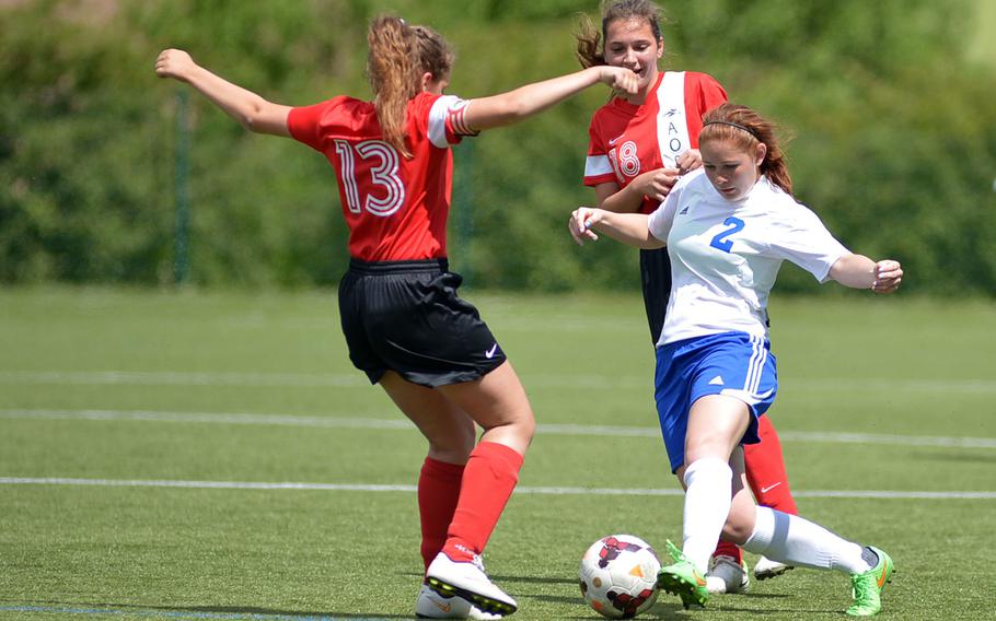 Hohenfels' Jessie Gamez weave her way through the AOSR defense of Leona Caanen, left, and Zoe Pipa  in a Division II semifinal at the DODDS-Europe soccer championships at Reichenbach, Germany. Hohenfels won the game 3-0 to advance to Thursday's final against AFNORTH