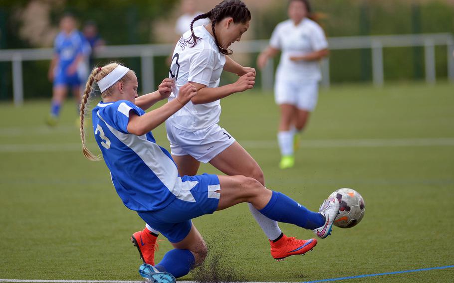 Wiesbaden's Catherine Klein, left, clears the ball from Ramstein's Ebony Madrid in a Division I semifinal at the DODDS-Europe soccer championships at Reichenbach, Germany. 