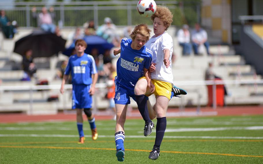 Sigonella's Nathan Jones heads the ball away from Florence's Brighton Steinberg in the boys Division III final at the DODDS-Europe soccer championships in Kaiserslautern, Germany. Florence won 4-0.
