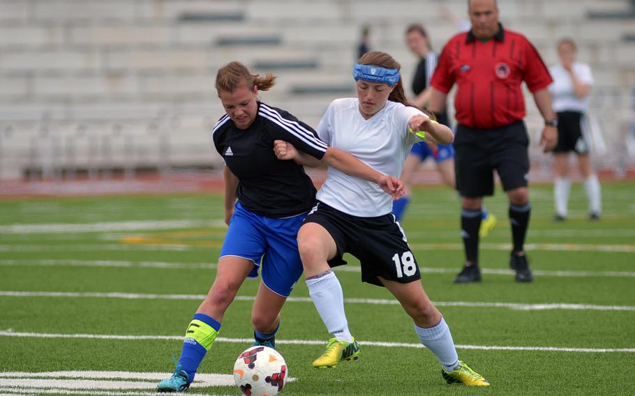 Hohenfels' Shelby Atkinson, left, and AFNORTH's Caitlyn Helwig battle for the ball in the girls Division II final at the DODDS-Europe soccer championships in Kaiserslautern, Germany. Hohenfels took the crown with a 1-0 win.