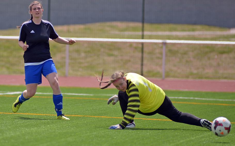 Hohenfels' Amelia Heath and AFNORTH keeper Frida Lund watch Heath's shot bounce into the goal for the game's only score as Hohenfels beat the Lions 1-0 in the girls Division II final at the DODDS-Europe soccer championships in Kaiserslautern, Germany.