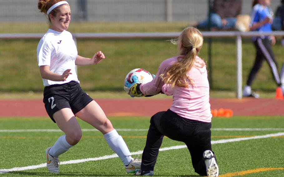 Brussels keeper Maria Vahrenhorst pulls in the ball against an attacking Isabel Black of Alconbury in the girls Division III final at the DODDS-Europe soccer championships in Kaiserslautern, Germany. Alconbury took the title with a 2-1 win.