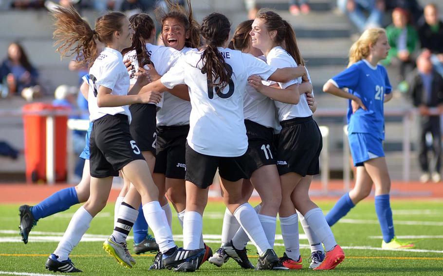 The Alconbury Dragons celebrate their Division III title after defeating Brussels 2-1 at the DODDS-Europe soccer championships in Kaiserslautern, Germany.