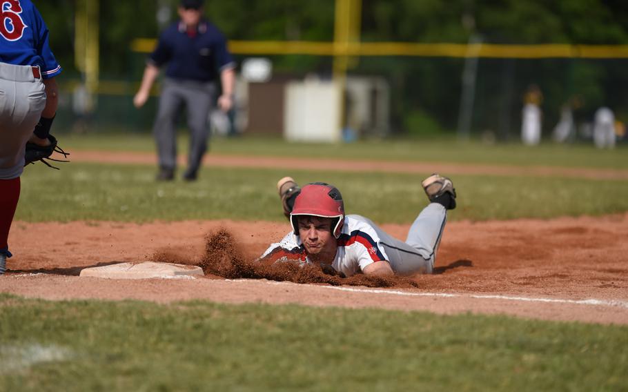 Lakenheath's  Trevor Roderick slides back to first during a pick-off attempt by Ramstein in pool play at the DODDS-Europe championships.
