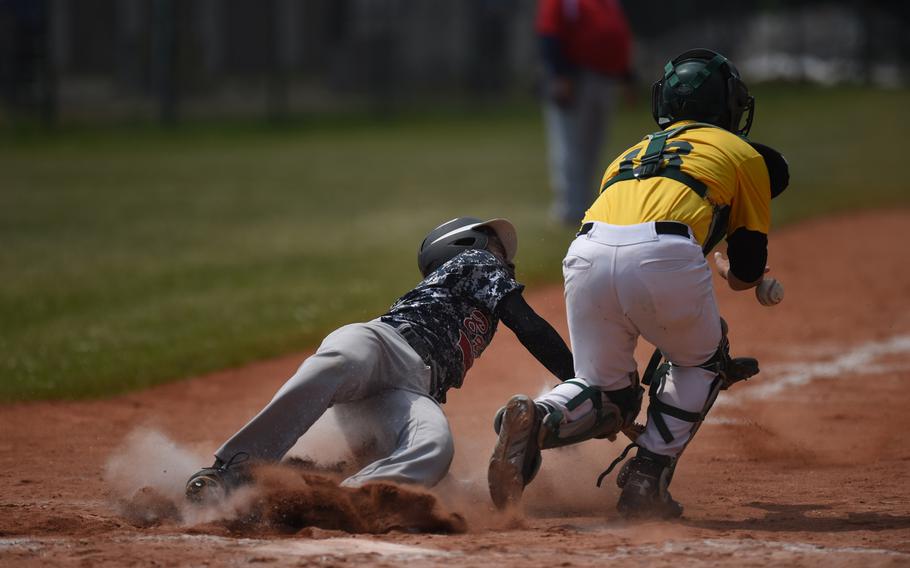 Bitburg's Jermaine Cooks slides in safe at home in the Barons' game against Alconbury in pool play at the DODDS-Europe baseball championships.